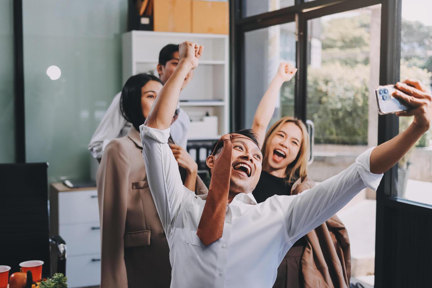 A group of people celebrating in an office photo