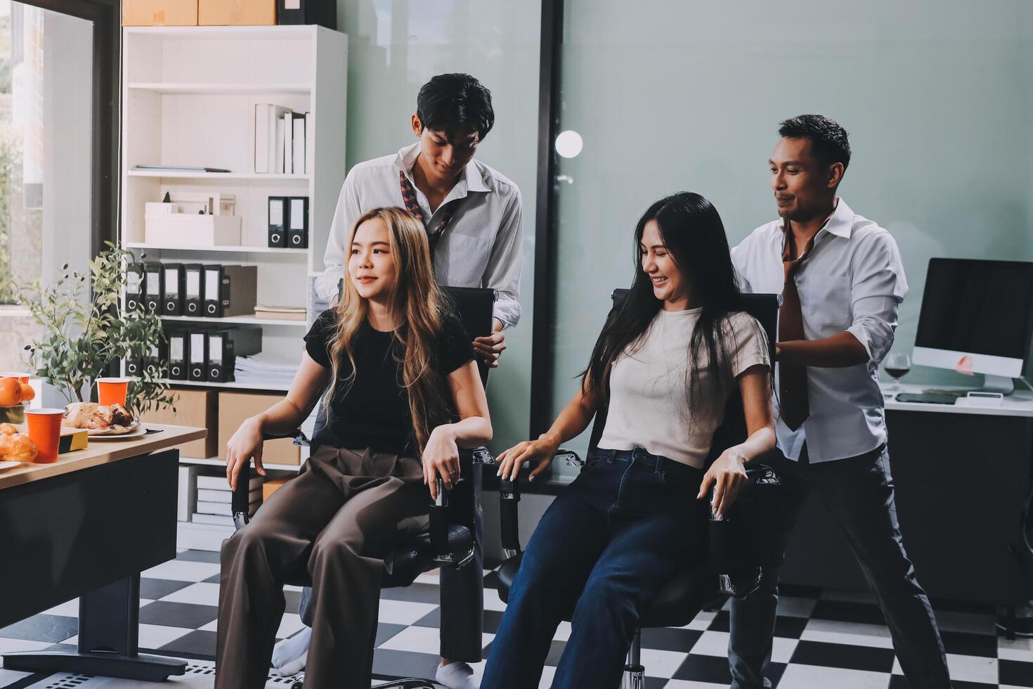 A group of people sitting in chairs in an office photo