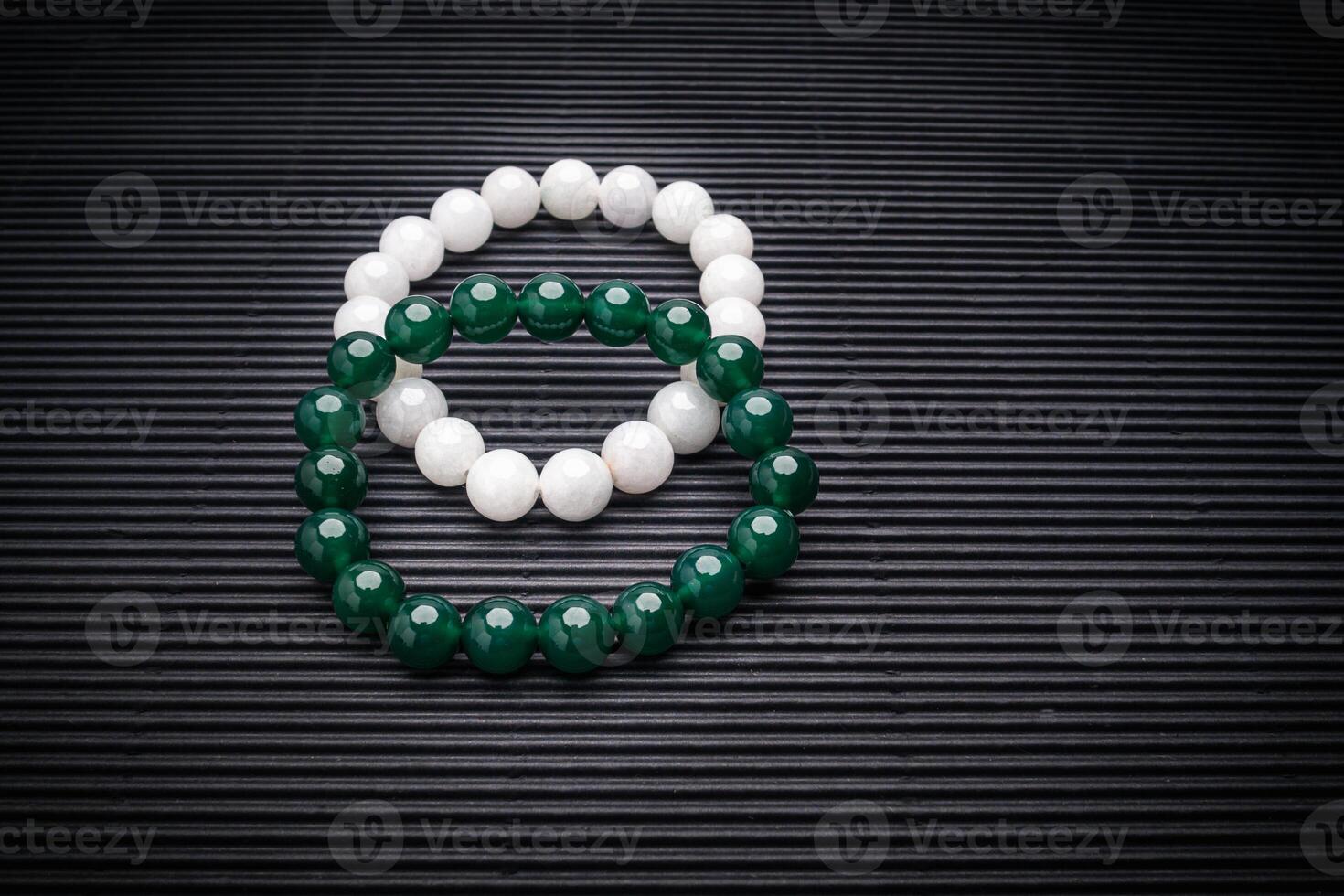 Close-up of two Jade bangles or bracelets on a black background photo