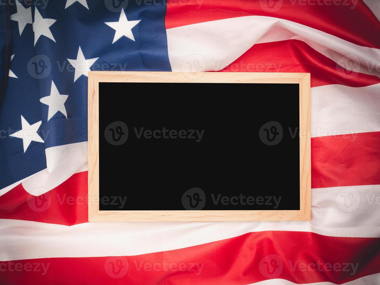 Top view of a mini chalkboard over the American flag background. Space for text. photo