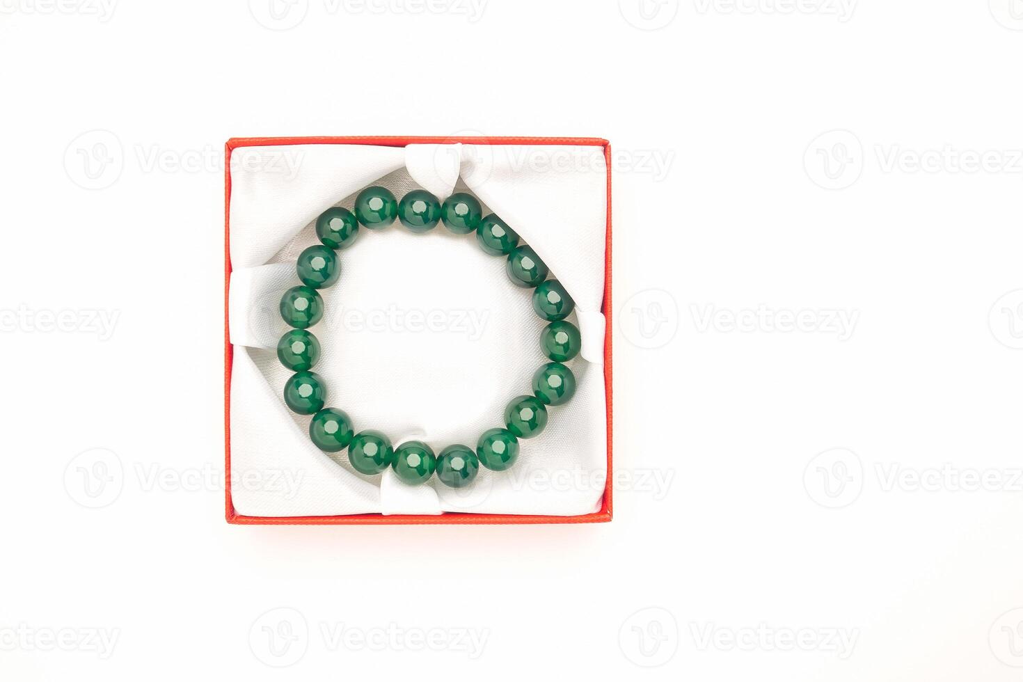 Top view of Jade bangle or bracelet in a red box on a white background photo