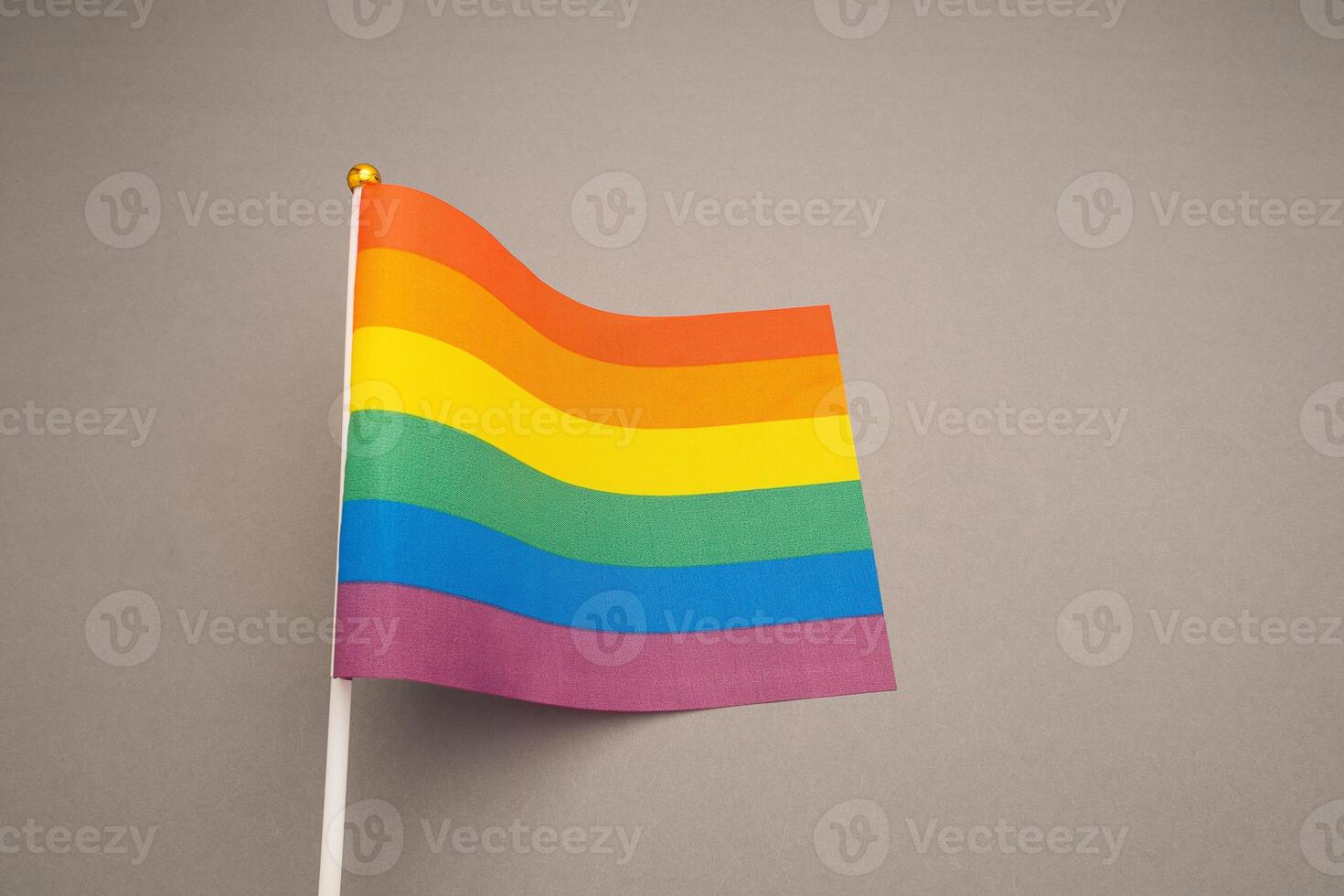 Rainbow flags or LGBTQ flag on a gray background. Close-up. photo
