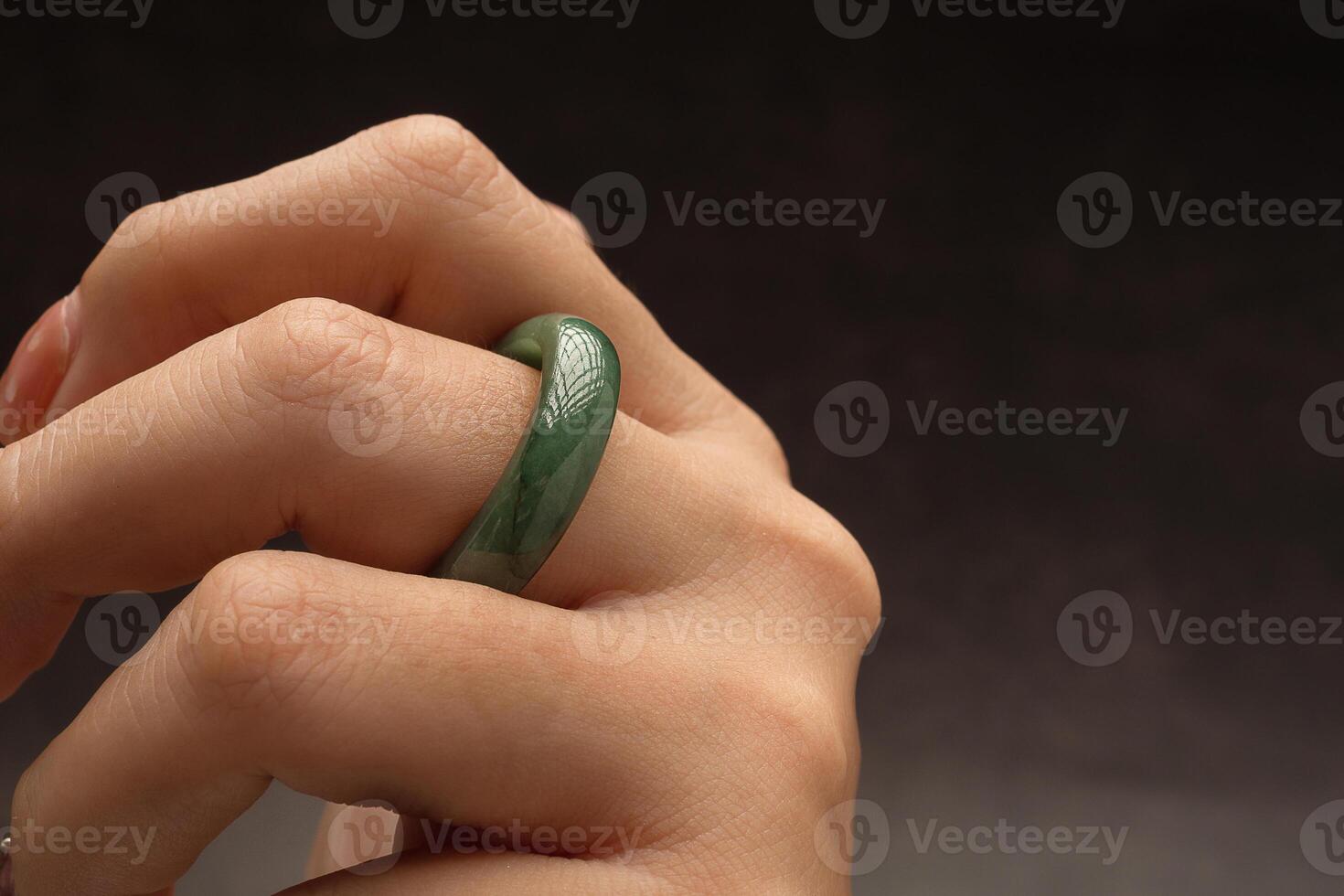 Close-up of woman's hand wearing a jade ring photo