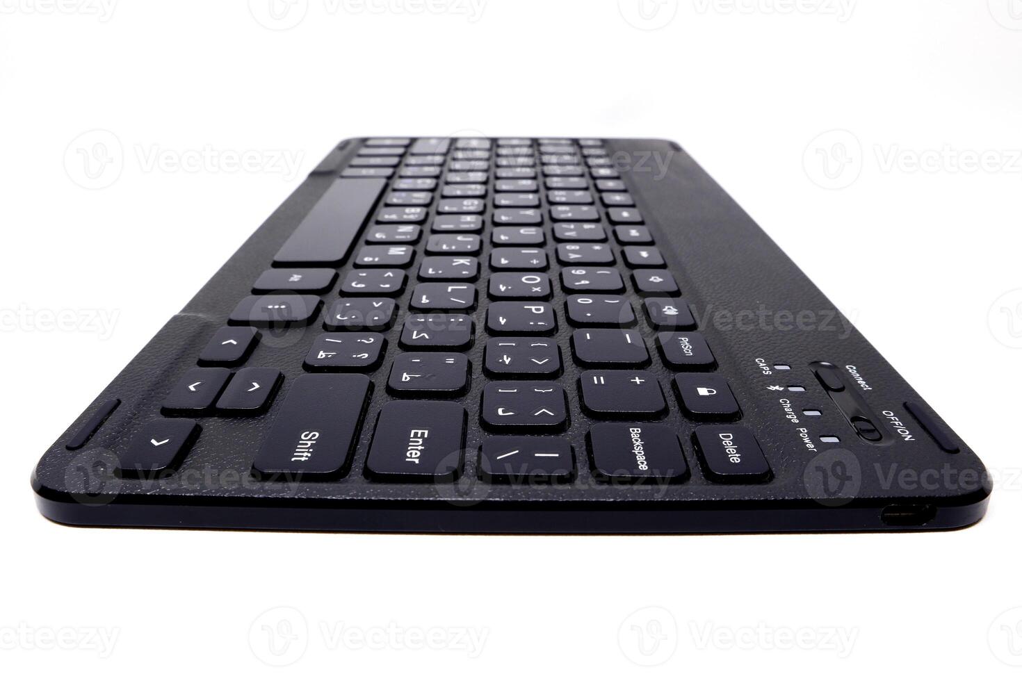 A black wireless keyboard on a white background photo
