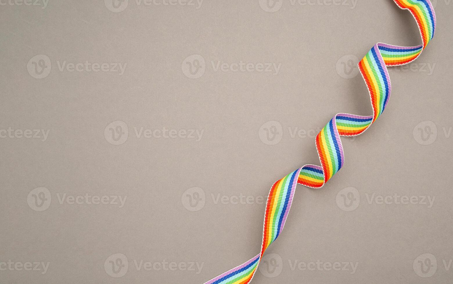Top view of a rainbow cloth ribbon on a gray background. photo