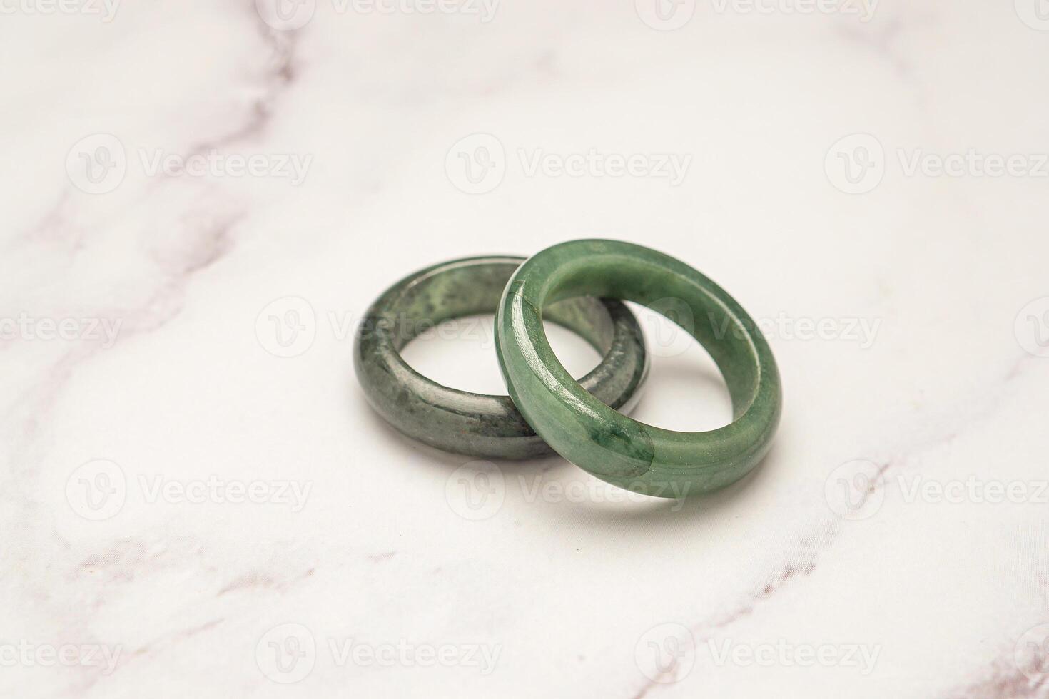 Green jade rings on a marble table photo