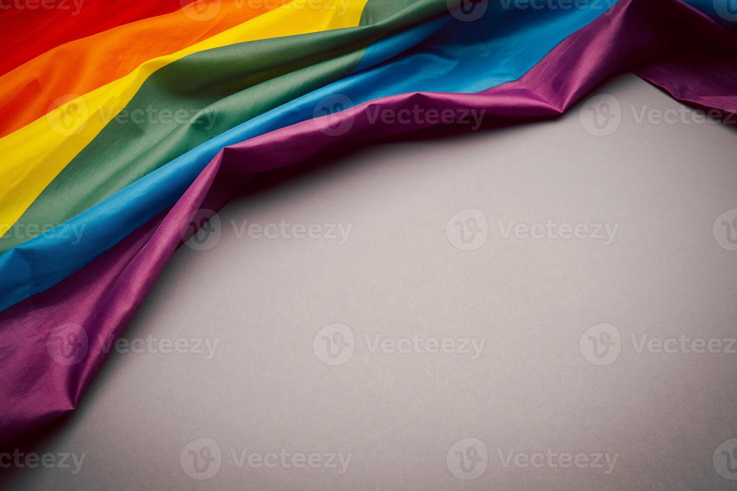 The rainbow flag or LGBTQ flag on a gray background. Top view. photo