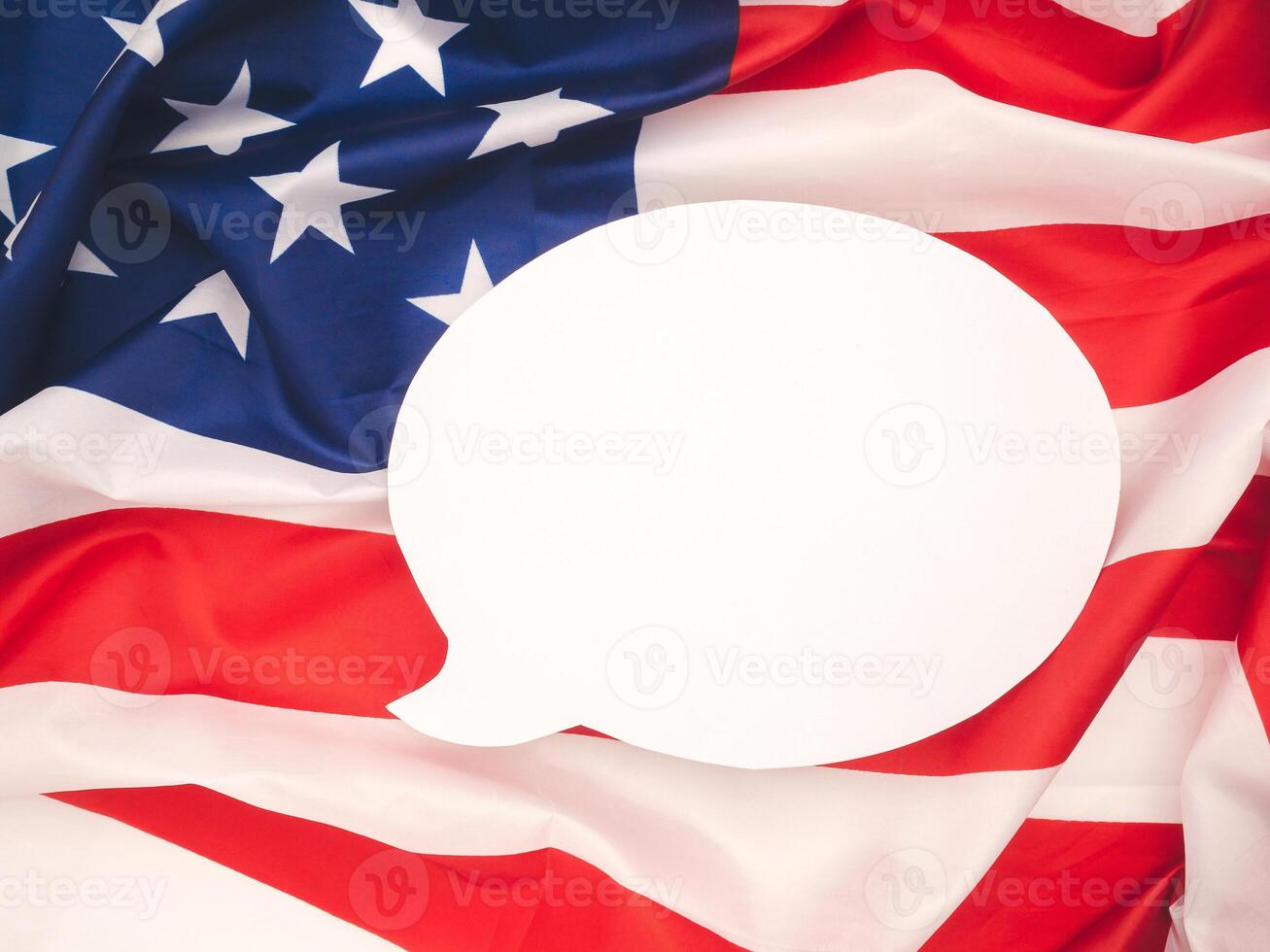 Top view of a blank white speech bubble over the American flag background photo