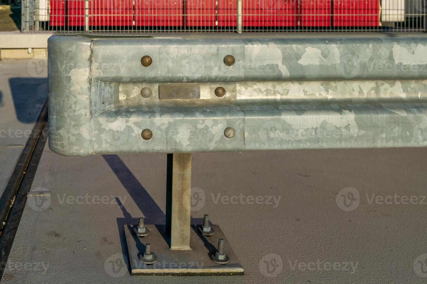 Metal safety barrier installed on a concrete surface in a construction area during daylight photo