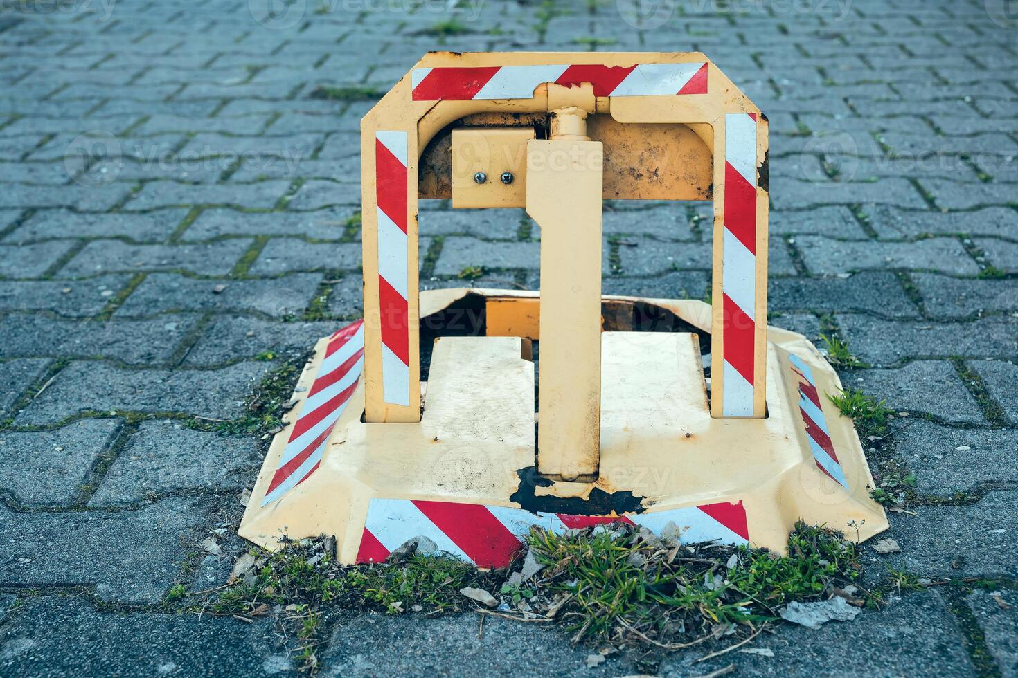 Traffic barrier on a sidewalk in an urban area, indicating road work and safety precautions during daytime hours photo