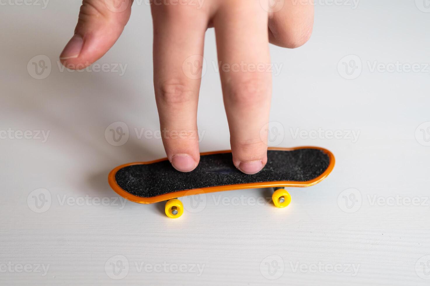 children's hands playing with a toy fingerboard, developing fine motor skills, selective focus photo