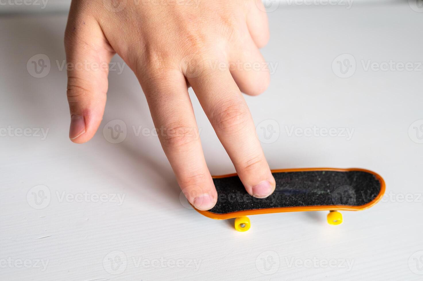 a hand holding a toy fingerboard photo