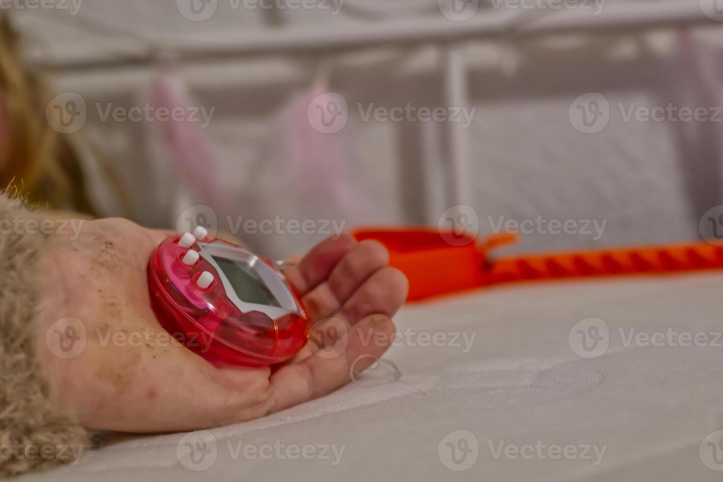 Close-up of a Pink Digital Timer on a Bed photo