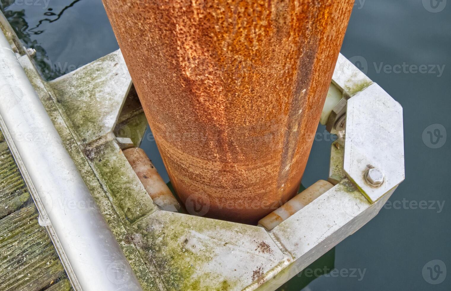 Rusty Metal Pole in Water with Bracket photo