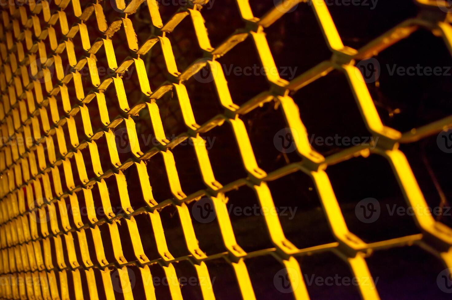 Close-Up of Yellow Metal Fence with Grid Pattern photo