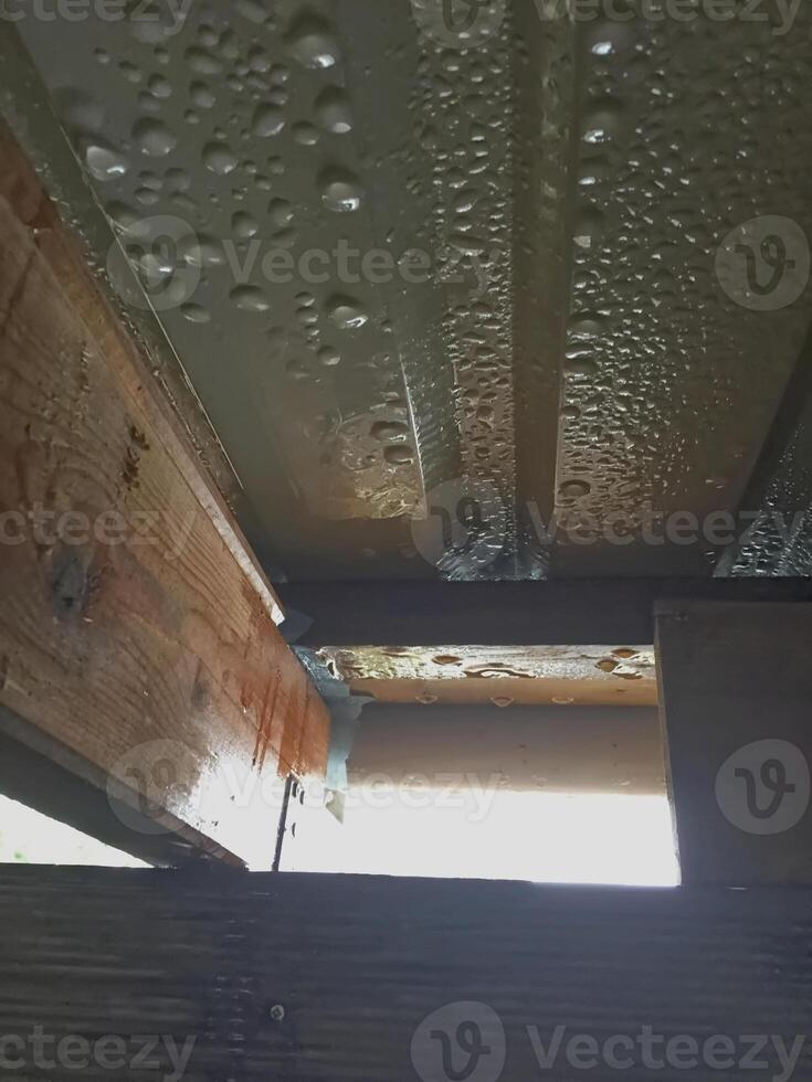 Water Droplets on Metal Roofing and Wooden Beams photo