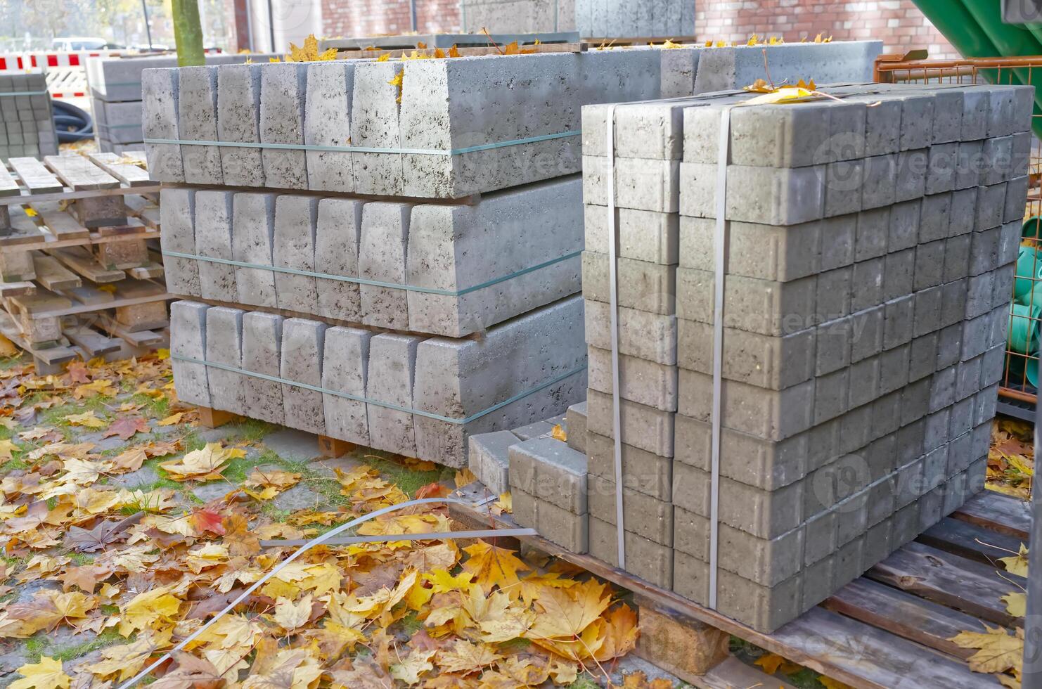 Stacks of Concrete Blocks Surrounded by Autumn Leaves photo