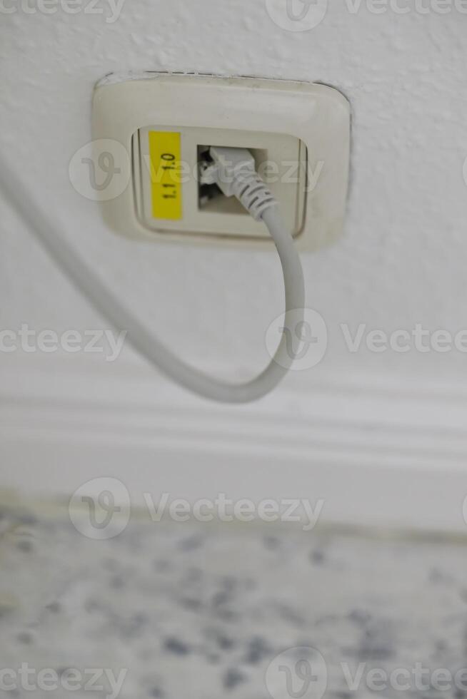 Close-up of Ethernet Wall Socket with Cable photo