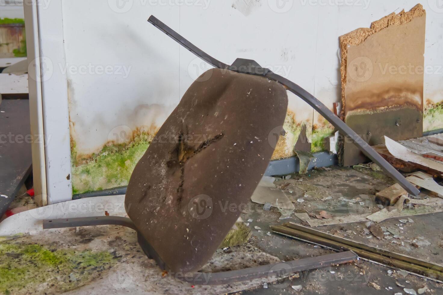 Abandoned Damaged Chair in a Dilapidated Room photo