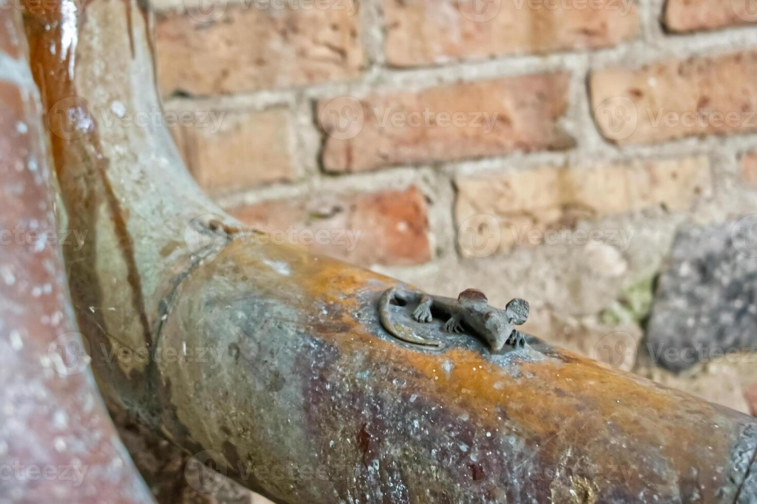 Rusty Pipe with Flensburger Kirchenmaus on Brick Wall photo