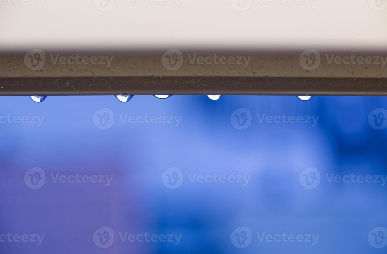 Water Droplets on a Ledge with Blue Background photo
