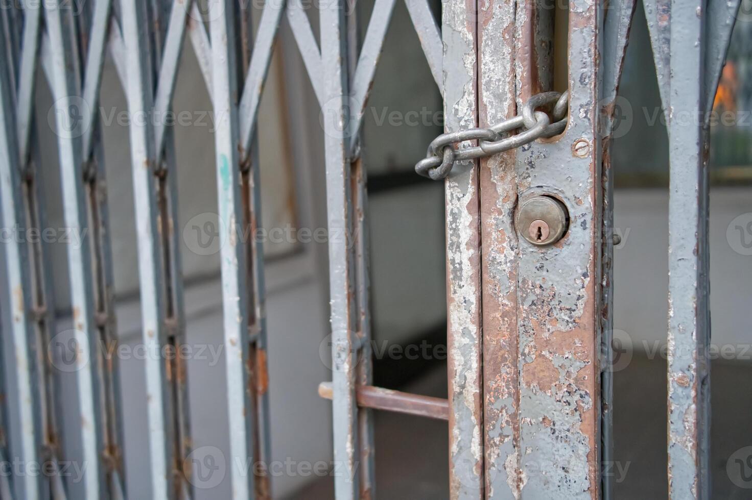 Rusty Locked Metal Gate with Chain and Padlock photo