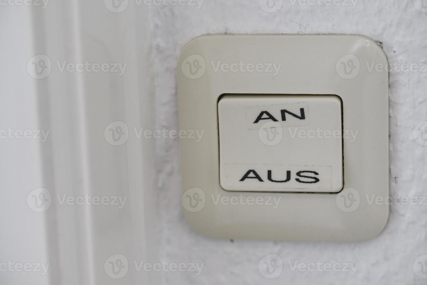 Close-up of Light Switch with German On and Off Labels photo
