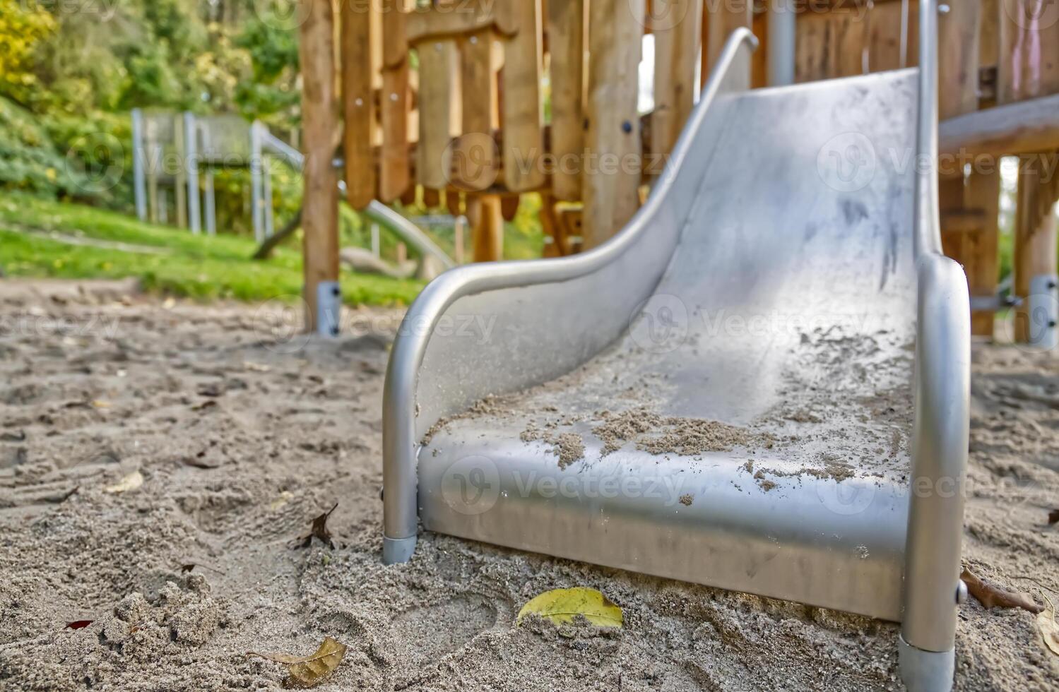 Close-Up of a Playground Slide in Sand photo