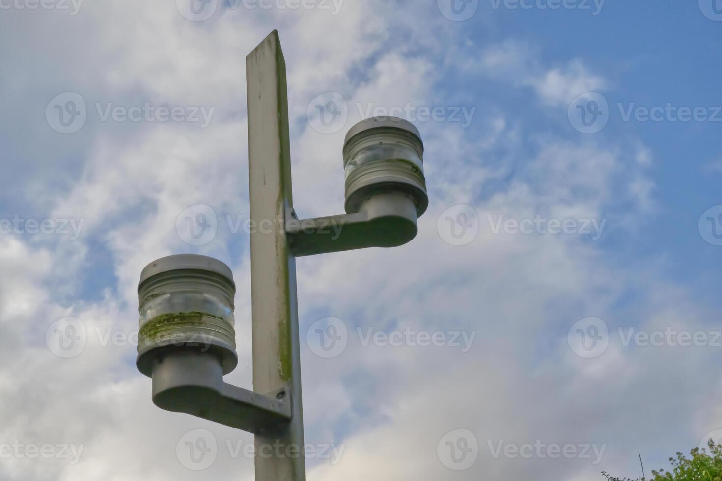 Weathered ship-lamps as Street Lamp against Cloudy Sky photo