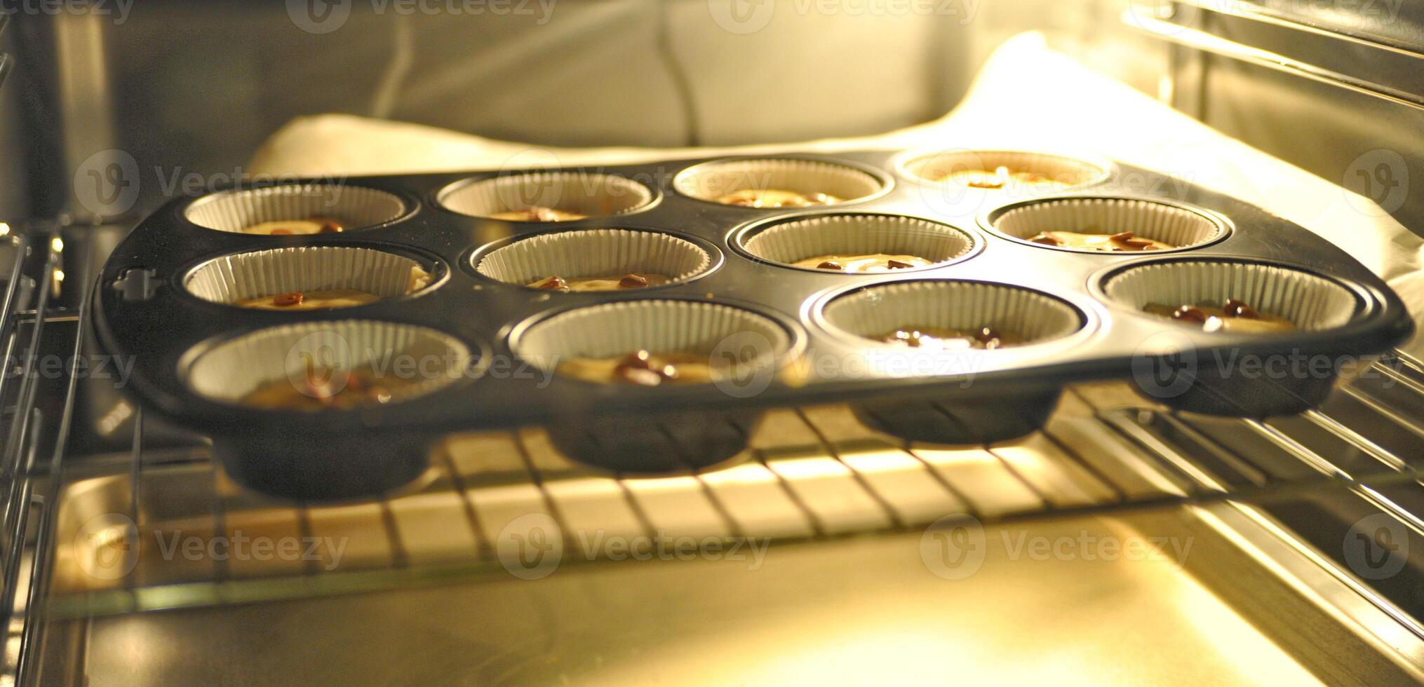 Muffin Tray Baking in Oven photo