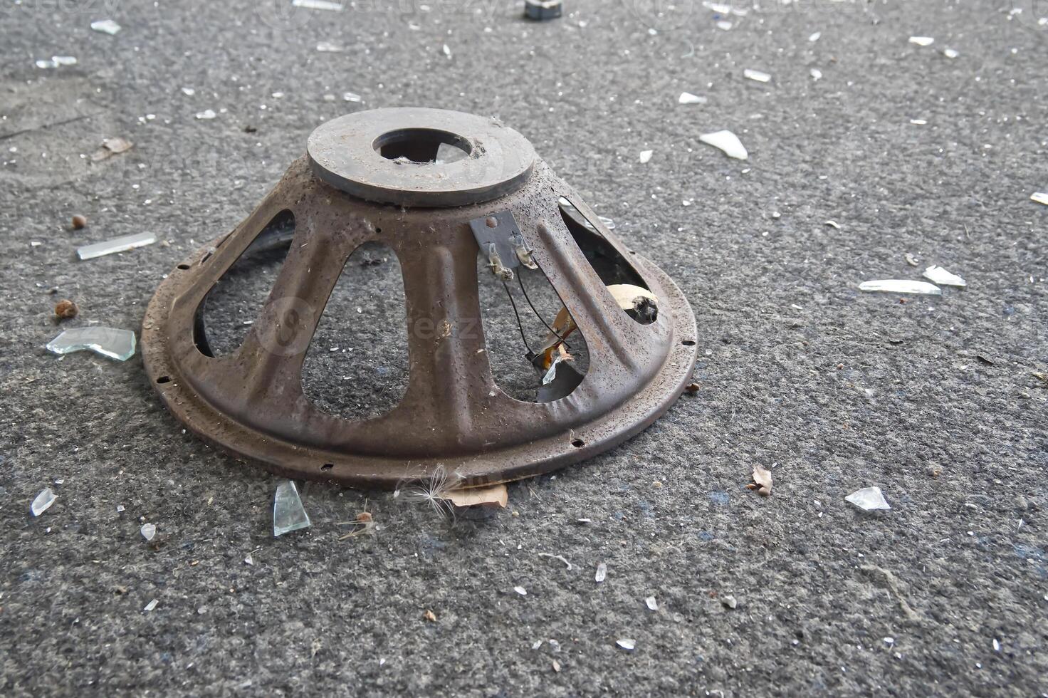 Rusty Speaker Cone on Carpet with Glass Shards photo