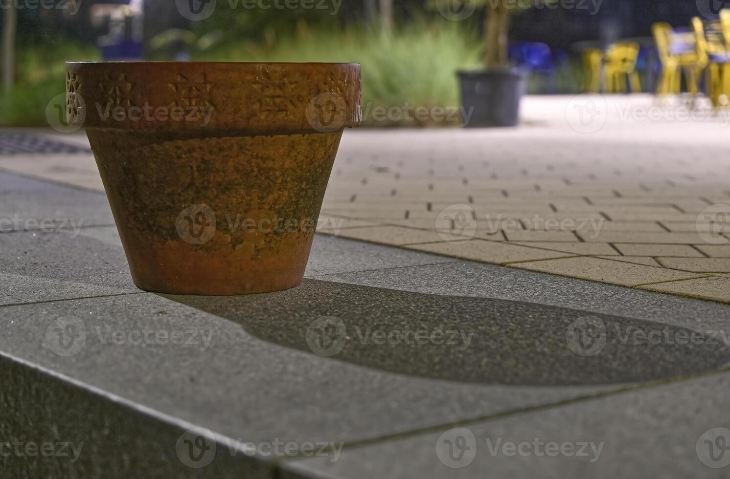 Terracotta Flower Pot Casting Shadow at Night photo