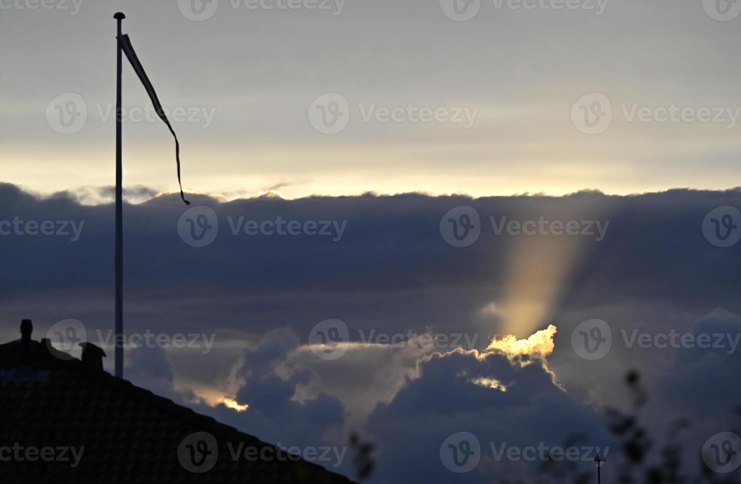 Dramatic Sunset with Rays of Light next danish flag danebrog photo