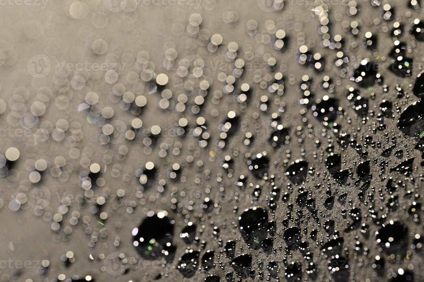 Close-Up of Water Droplets on Dark Surface photo