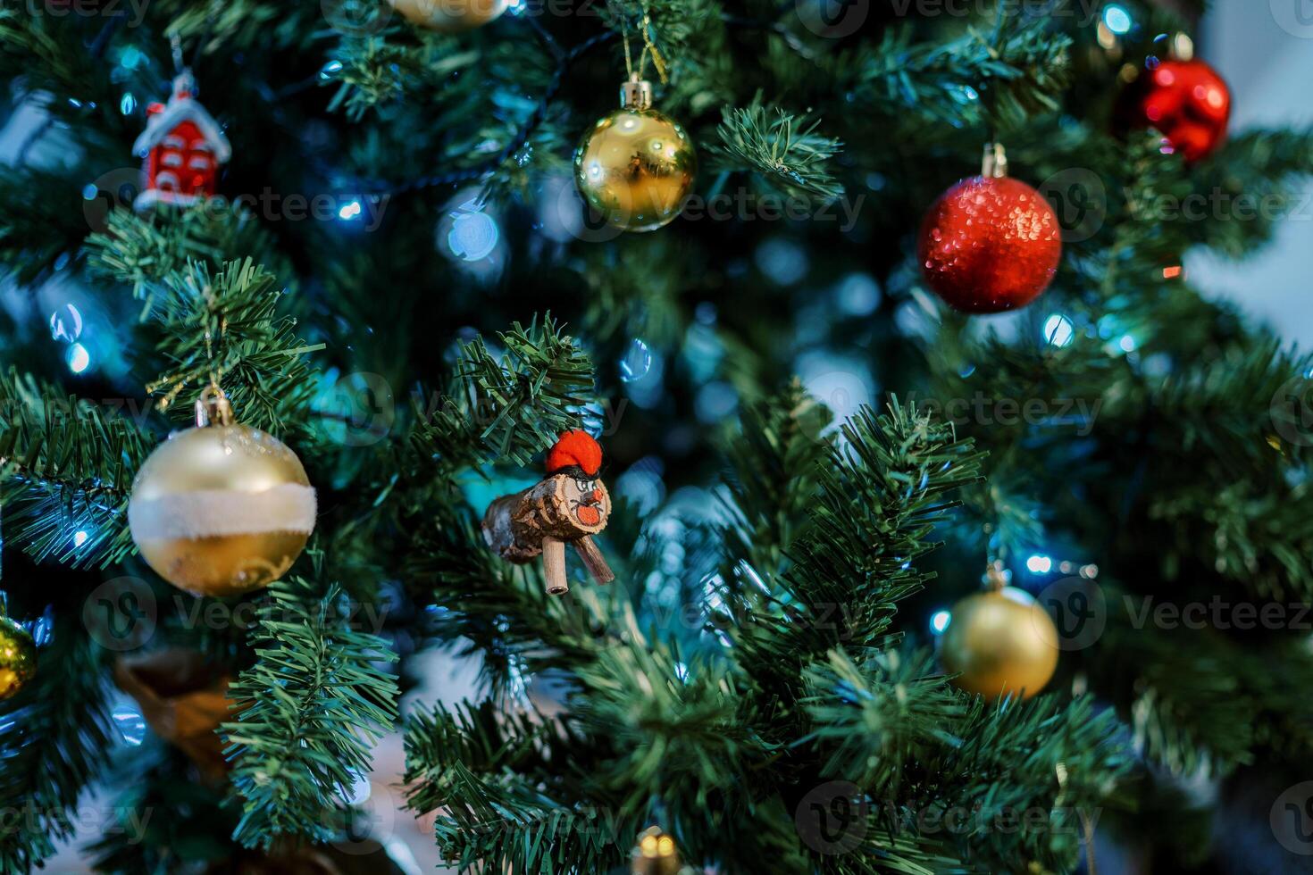 Colorful toys and balls hang on the branches of the Christmas tree photo