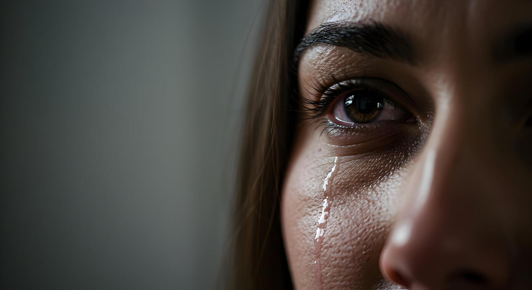 Close Up of Woman Crying with Tear Running Down Face photo