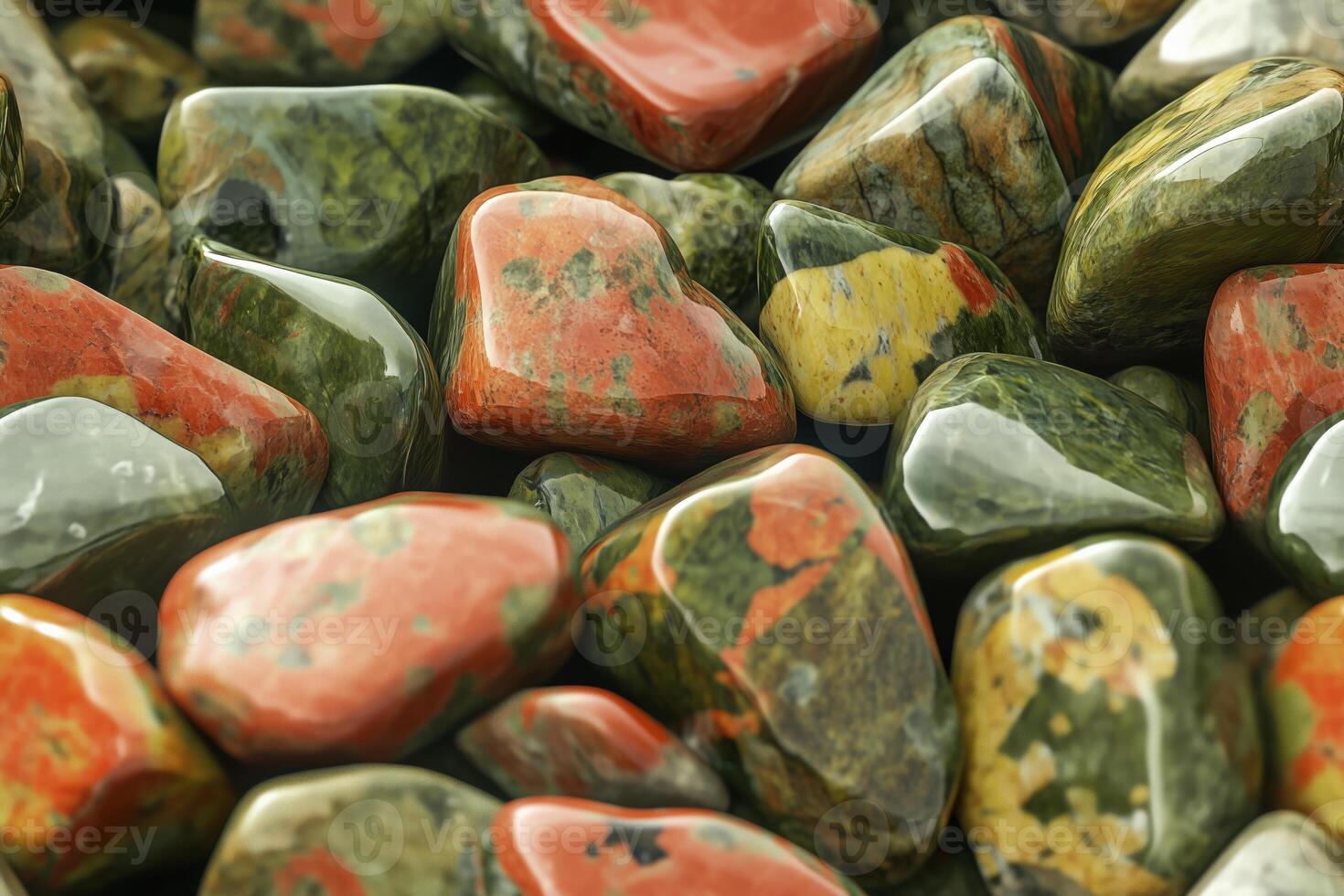 A pile of colorful rocks with green, red and yellow stones photo