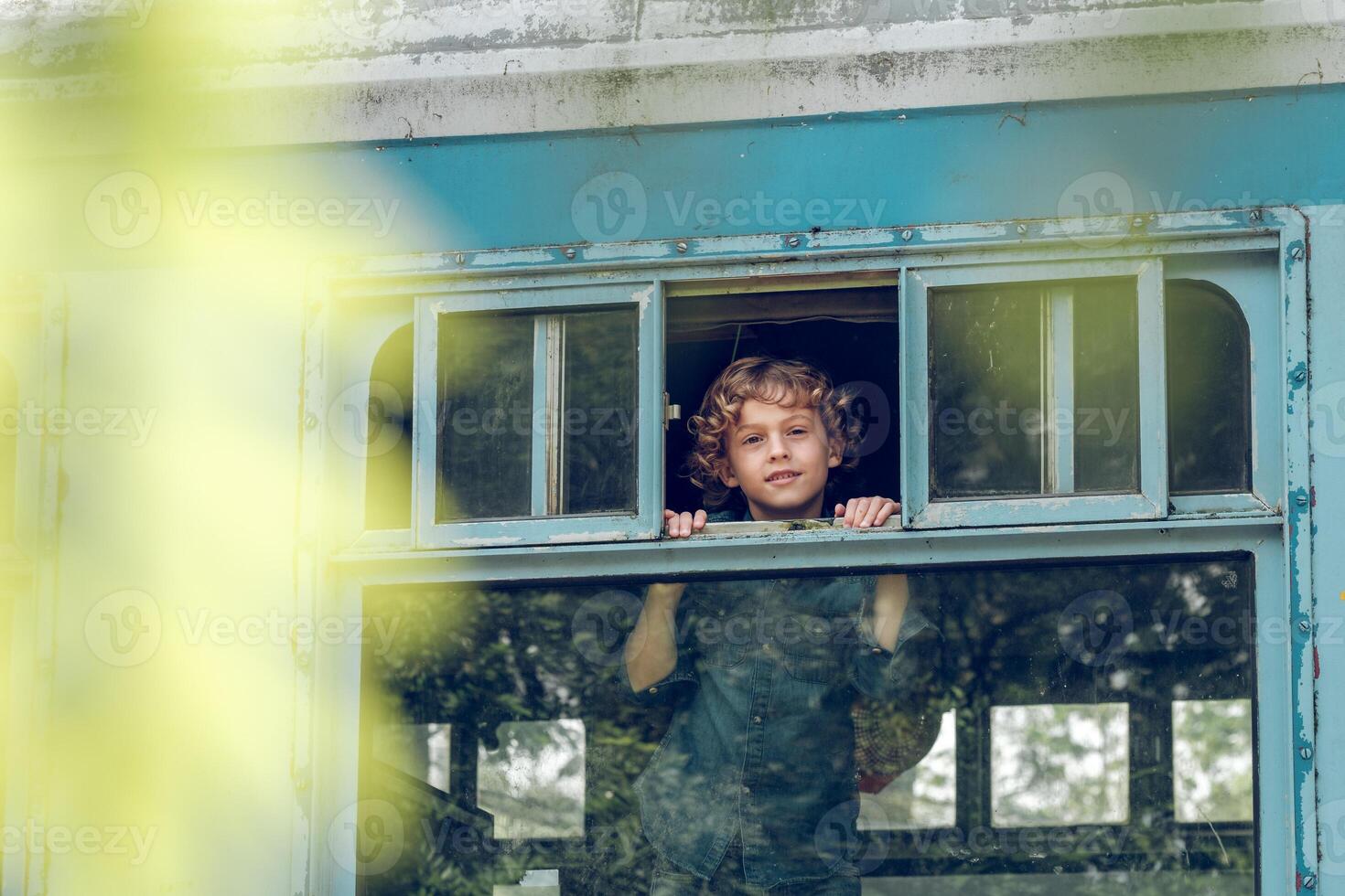 Smiling boy in train near window photo