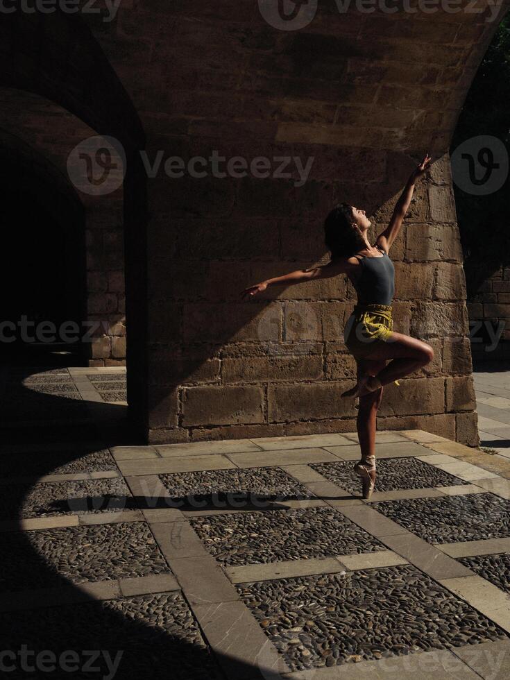 Faceless slim woman dancing ballet on street photo