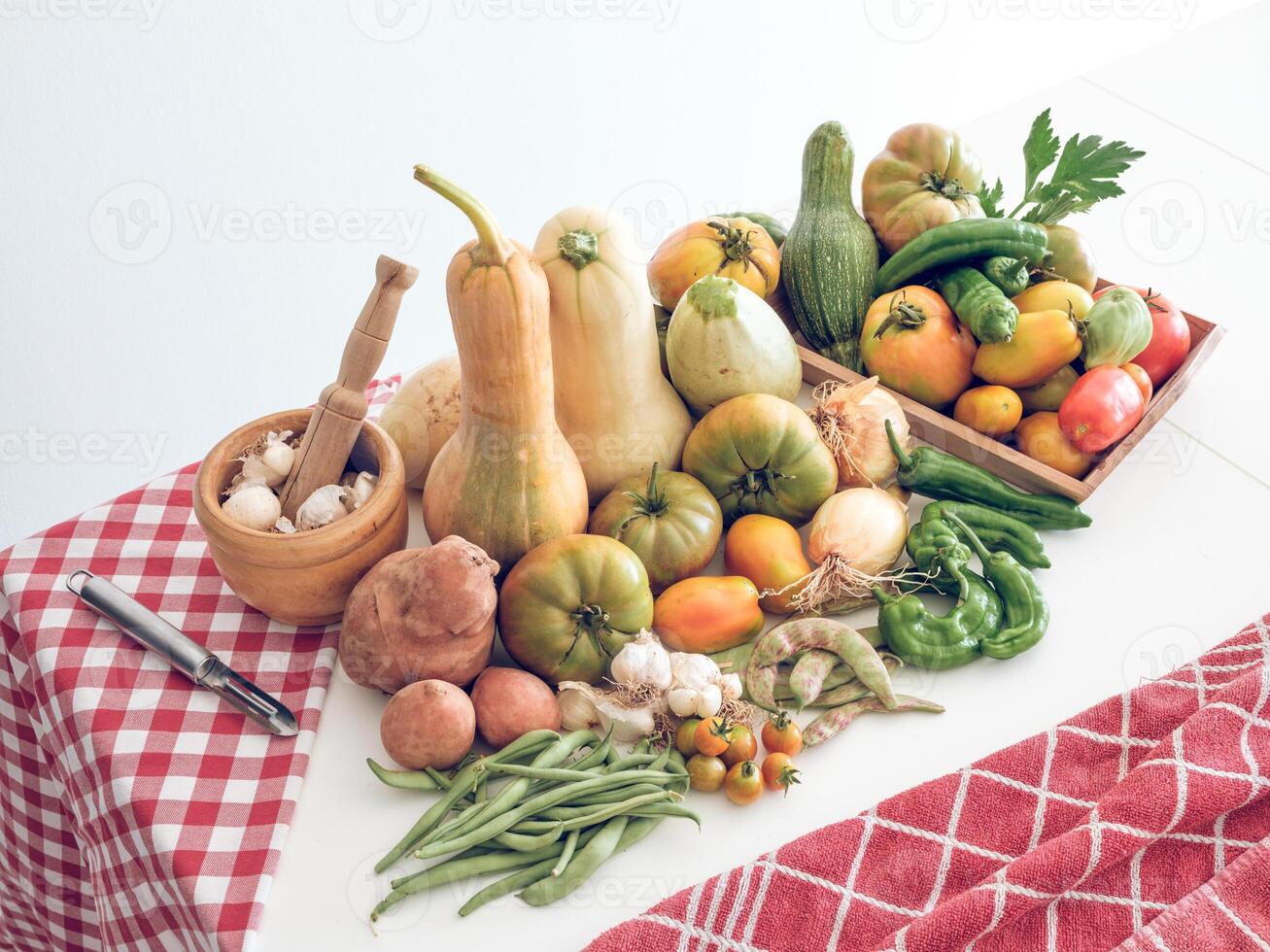Various fresh vegetables and utensils on table photo