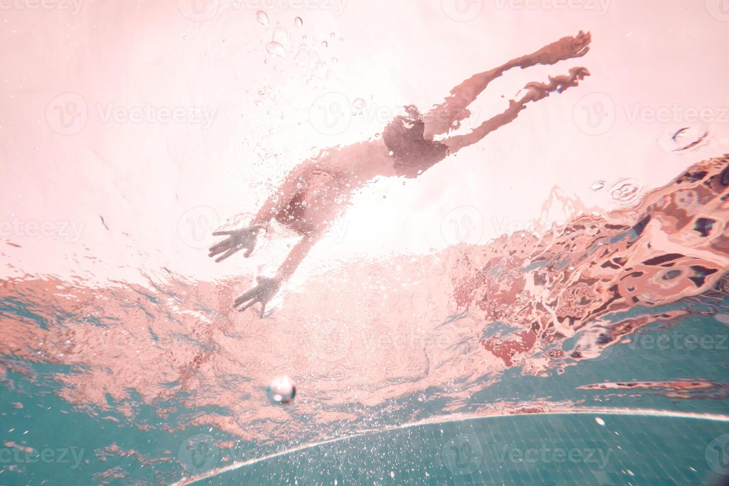 Anonymous man swimming in clear pool water photo