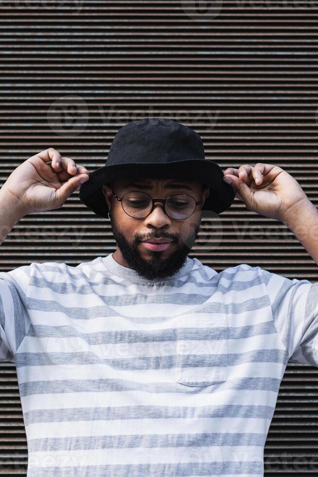 Back hipster man in hat looking down photo