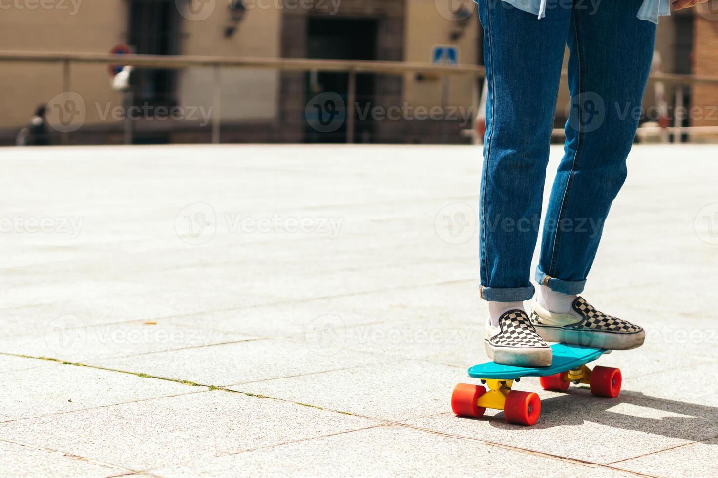 Girl skating in a urban square. close-up photo