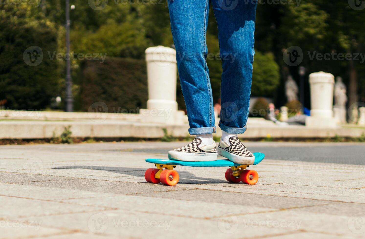girl skating on a city square. close-up photo