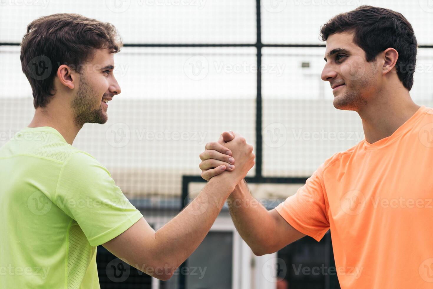 two young man paddle players shaking hands after game. fair play photo