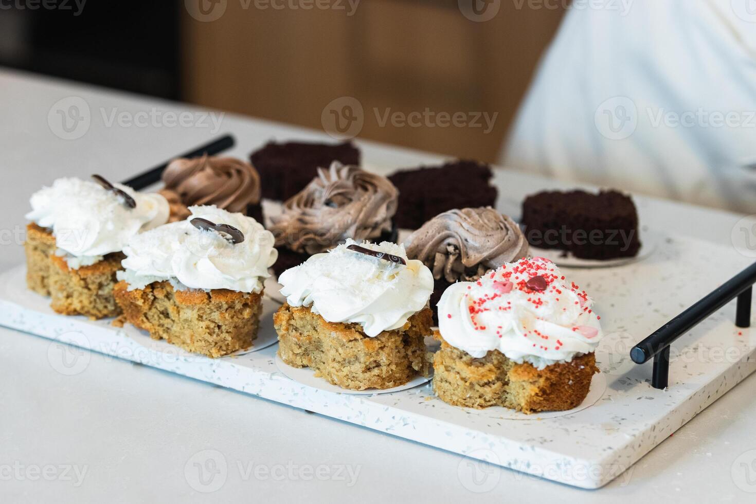 Appetizing carrot cakes on tray in kitchen photo
