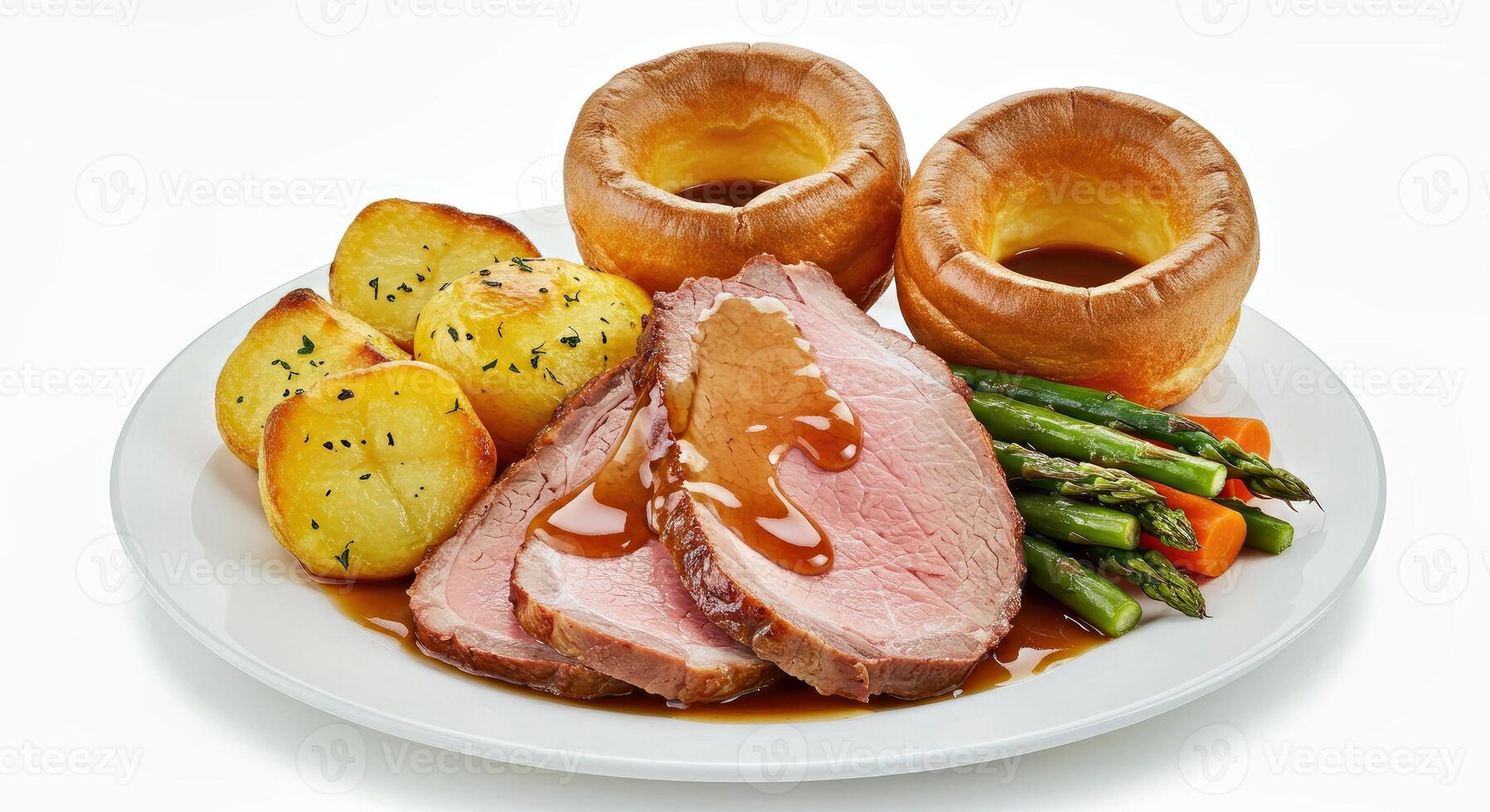 A plate with roast beef, potatoes, asparagus and gravy photo