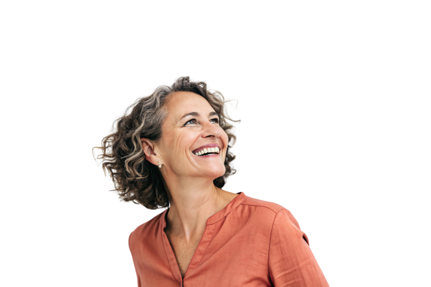 A confident middle-aged woman with curly hair, wearing an orange blouse, smiles warmly while looking upwards, radiating a sense of grace and joy png