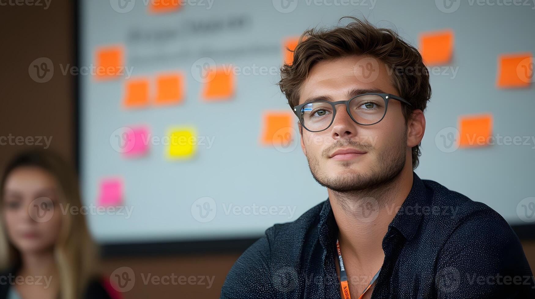 Professional workshop environment, participants in a training session actively discussing during a Q and A, whiteboard with colorful sticky notes in background photo