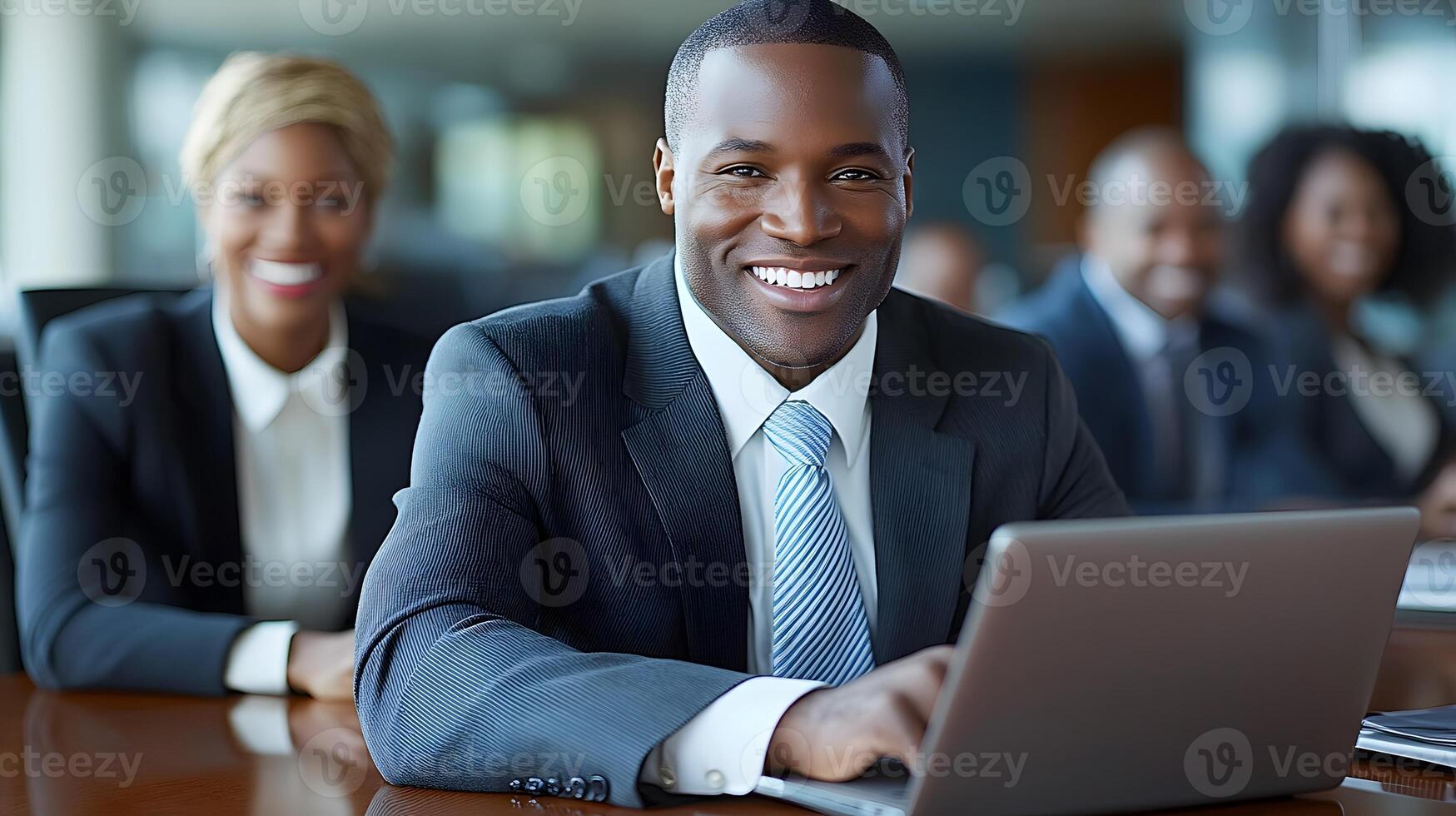 Diverse group of colleagues smiling and focused on laptop symbolizing teamwork and unity. photo
